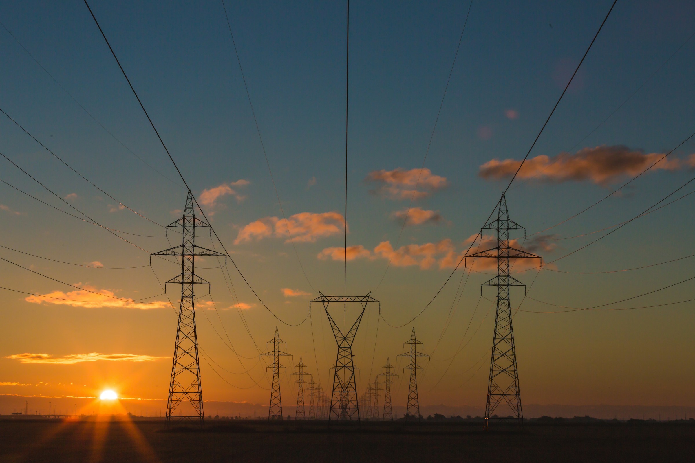 A network of transmission lines stretching across a landscape